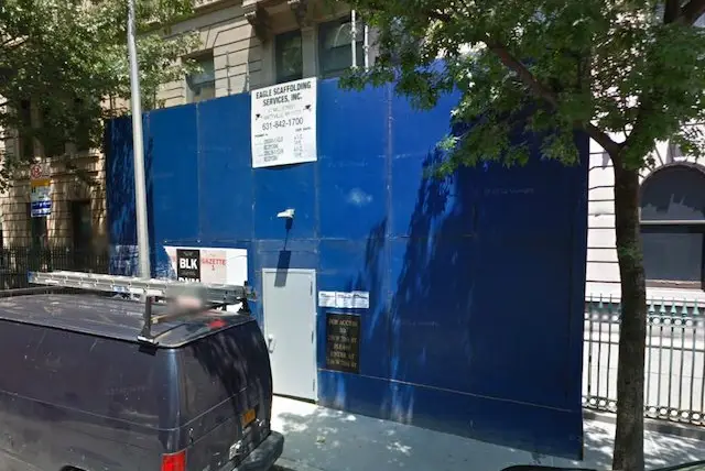 A blue construction wall erected near 235 West 75th Street by Eagle Scaffolding